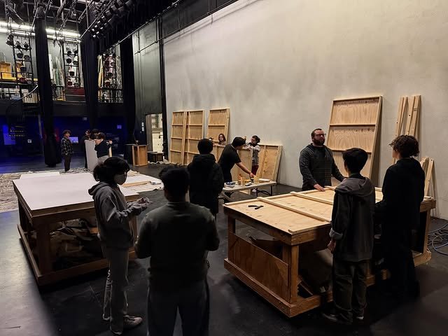 Students building set platforms in the scene shop