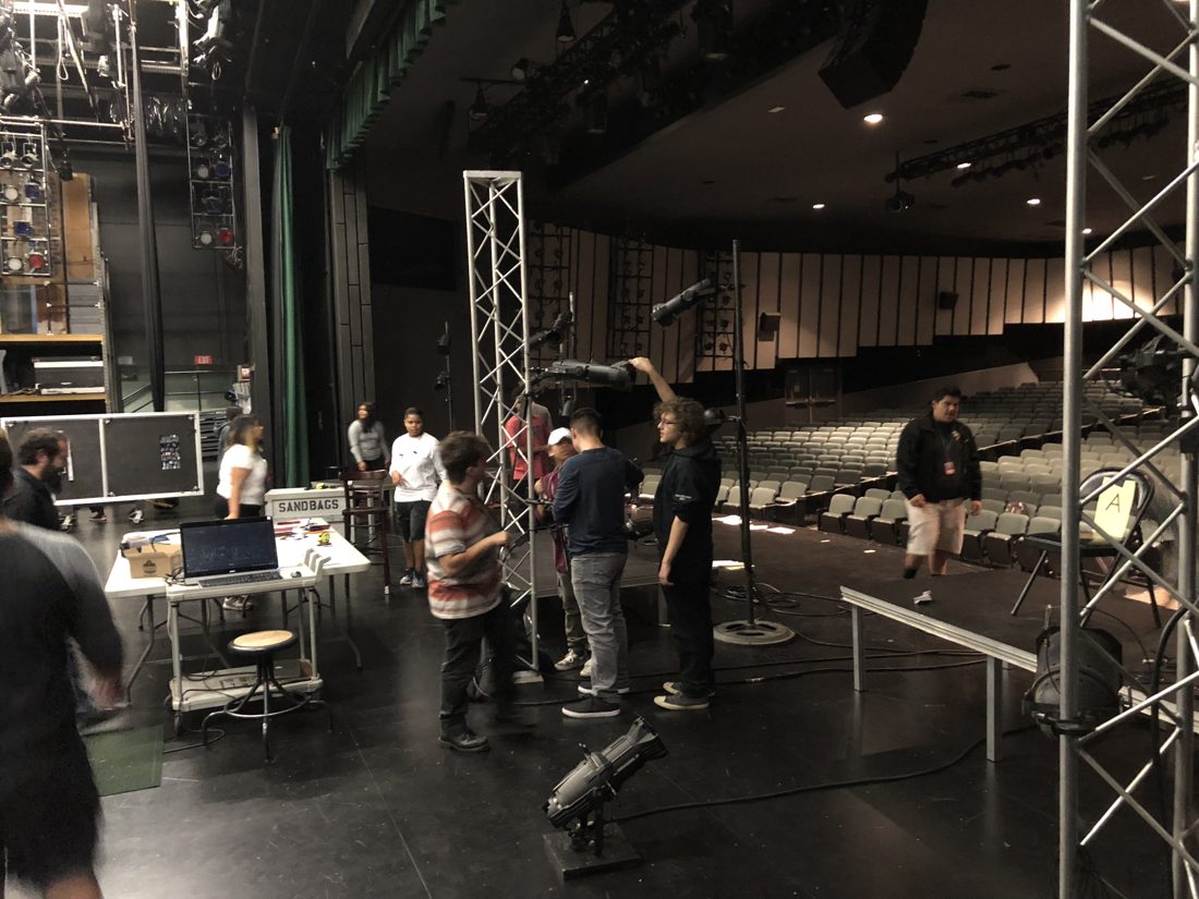 Students assembling truss towers on stage